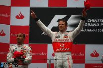 Button leads McLaren to one-two in wet race