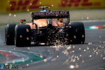 Sparks fly from the rear of Lando Norris, McLaren MCL35M