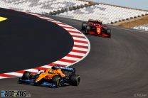 Carlos Sainz, Ferrari SF21, leads Lando Norris, McLaren MCL35M leaving corner