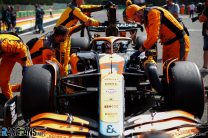 Daniel Ricciardo, McLaren MCL36, on the grid with mechanics