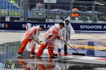 Marshals sweep the circuit of rain water, Singapore, 2022
