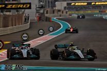 (L to R): George Russell, Lewis Hamilton, Mercedes, Yas Marina, 2022
