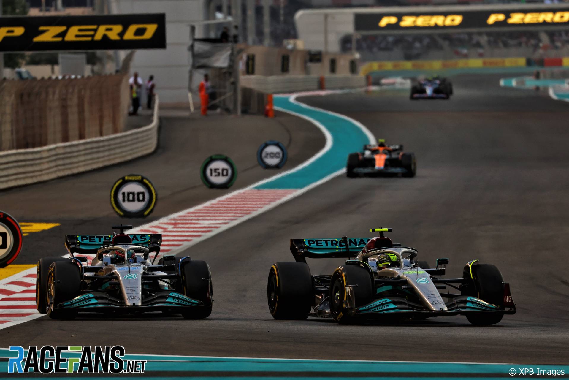 (L to R): George Russell, Lewis Hamilton, Mercedes, Yas Marina, 2022
