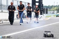 Lewis Hamilton and Esteban Ocon racing remote control cars in the pit lane at Suzuka